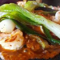 Molcajete · Chicken, steak & shrimp slow-cooked with Nopal, served with cheese and onions in a special s...