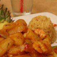 Sinaloense Tropical · Shrimp in our special sauce in a pineapple,
green onions, garlic, vegetables, and Spanish ri...