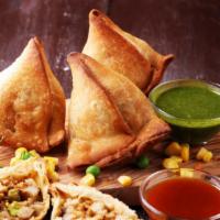 Vegetable Samosa · Turnovers stuffed with potatoes and green peas
(Two pieces.)