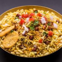 Bhel Puri · Rice puffs, crispy noodles, potatoes, green chili, onions and cilantro tossed with tamarind ...
