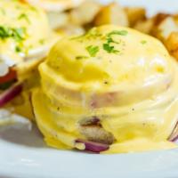Blackstone Benedict · Grilled red onions, tomatoes, avocado and poached eggs on an english muffin with hollandaise...