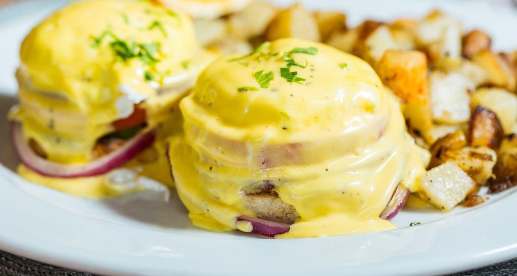Blackstone Benedict · Grilled red onions, tomatoes, avocado and poached eggs on an english muffin with hollandaise sauce.