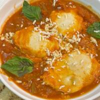 Shakshuka · Two eggs poached with onion, bell pepper, jalapeno,  cumin and garlic, topped with queso fre...