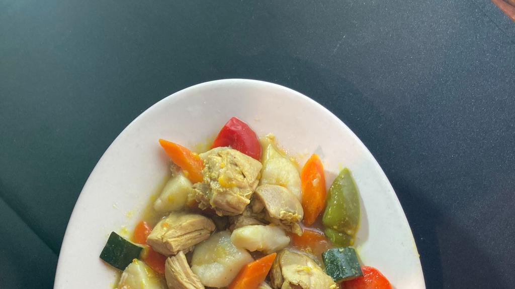 CHICKEN CURRY OVER RICE · Chicken thigh in a semi-spicy yellow curry sauce with potato, carrot, bell pepper, squash, zucchini and onion