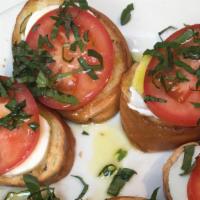 Caprese Salad · Fresh mozzarella, tomato, basil and olive oil on toasted slices of baguette.