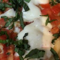 Caprese Mini Pizza · Chopped fresh tomato, garlic, fresh melted mozzarella, olive oil and topped with fresh basil.