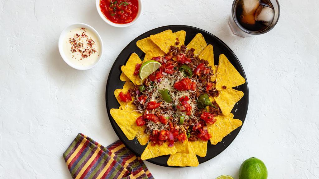 Nachos · Delicious plate of Corn Chips, Beans, Cheese, and salsa. Served to customer's preference.