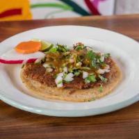 Taco de Carnitas · one crispy fried pork taco topped with  onion, cilantro, salsa