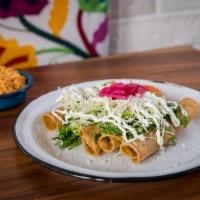 Flautas · four crispy tortillas filled with chicken, topped with lettuce, cabbage, crema, queso cotija...