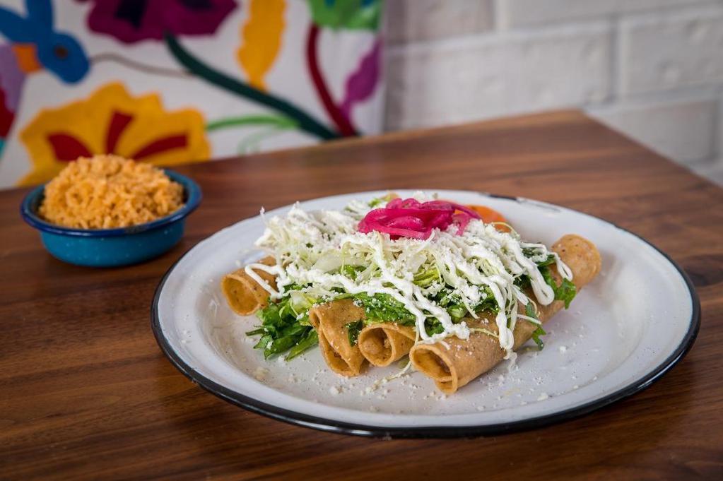 Flautas · four crispy tortillas filled with chicken, topped with lettuce, cabbage, crema, queso cotija, pickled onions, salsa, served with rice