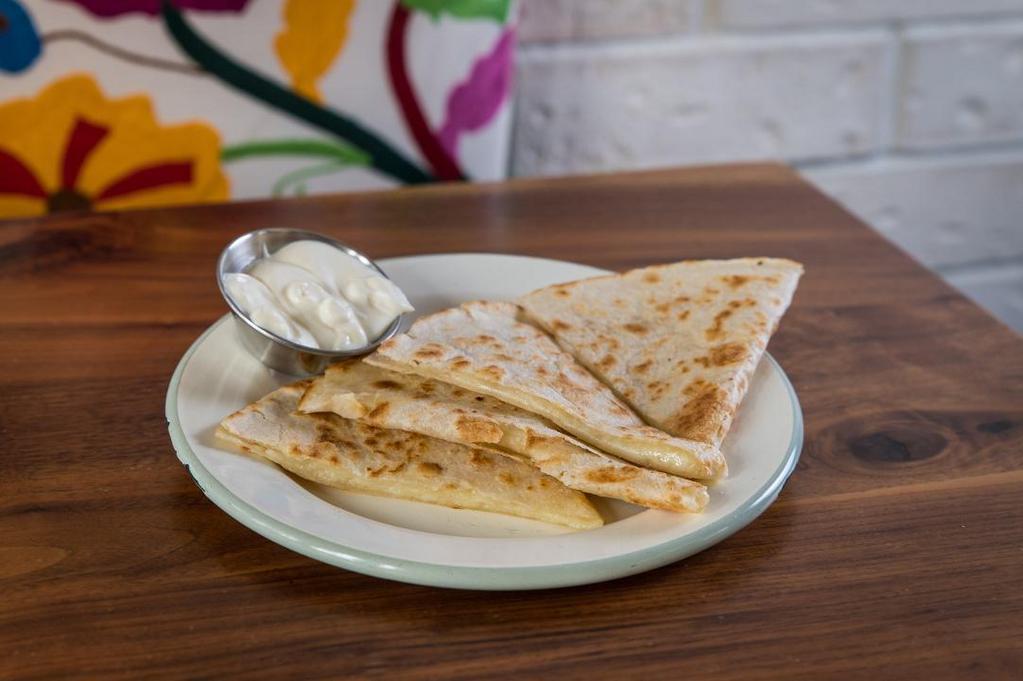Kids Quesadilla · Flour quesadilla served with a side of sour cream