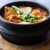 Kimchi Stew · Moderately spicy. Kimchi with beef, tofu, glass noodles, onions, and sliced rice cakes.