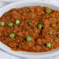 Baingan Bharta · Roasted eggplant cooked with green peas and spices.