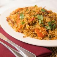 Chicken Biryani · Traditional rice dish cooked with curry, cashews, raisins and a coconut garnish.