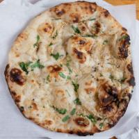 Garlic Naan · Popular naan bread enriched and baked with aromatic spiced fresh garlic and coriander leaves.
