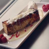 White Chocolate Bread Pudding · White chocolate & raspberry sauces, fresh raspberries, and whipped cream
