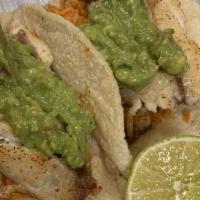 Tilapia Taco (1) · Homemade corn tortilla topped with rice, grilled tilapia, guacamole and tomato.