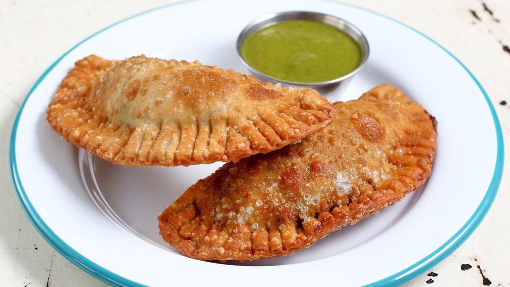 Picadillo Empanadas · spiced ground beef and famous green sauce.