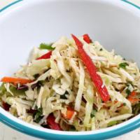 Coconut Slaw · shredded cabbage, bell pepper, toasted coconut, cilantro, and lime.