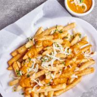 Garlic Tikka Fries · Vegetarian. Potato fries tossed w/ minced garlic, Parmesan cheese & onions in a tikka sauce ...