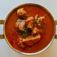 Mutton Kuzhambu · Goat with bones cooked with chettinad spices.