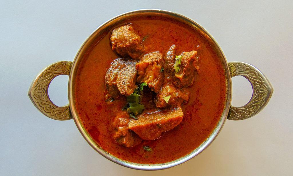 Mutton Kuzhambu · Goat with bones cooked with chettinad spices.