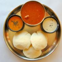 Idly W/ Chicken Curry · Three pcs of steamed rice cakes served with chutneys and chicken curry.