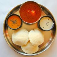 Idly W/ Fish Curry · Three pcs of steamed rice cakes served with chutneys and fish curry.