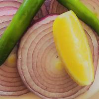 Side Salad · Onion slices. slitted green chillies & lemon wedge.