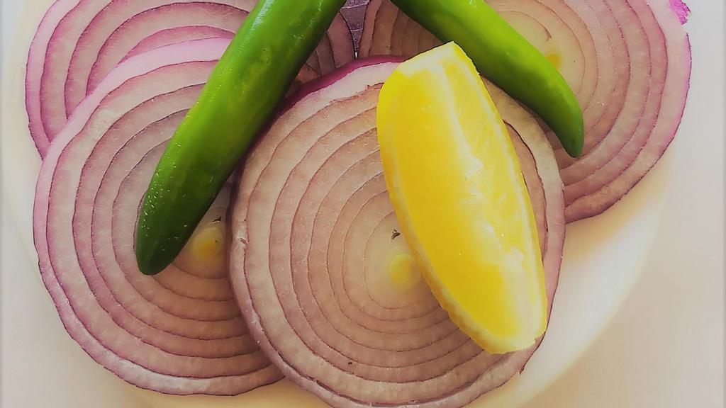 Side Salad · Onion slices. slitted green chillies & lemon wedge.