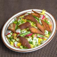 Fatouche Salad · Lettuce, cucumber, tomatoes, onions and pita chips, parsley, sumac, olive oil and lemon juice