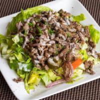 Beef shawarma salad · mixed salad topped with thinly sliced beef shawarma and tahini sauce