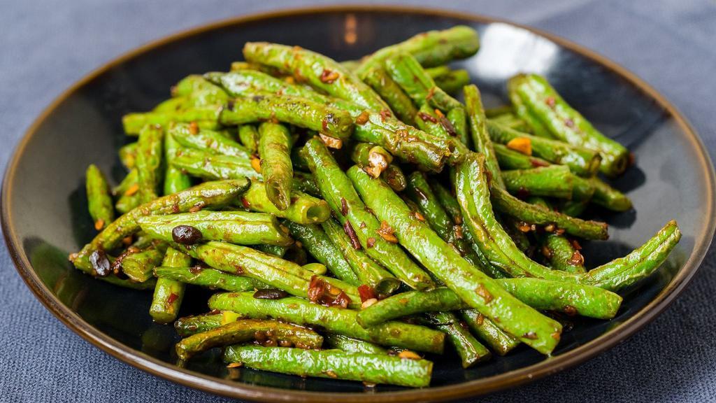 Sichuan Green Beans · Vegetarian. Dry-braised in a spicy, ginger, garlic, brown bean, and chili sauce.