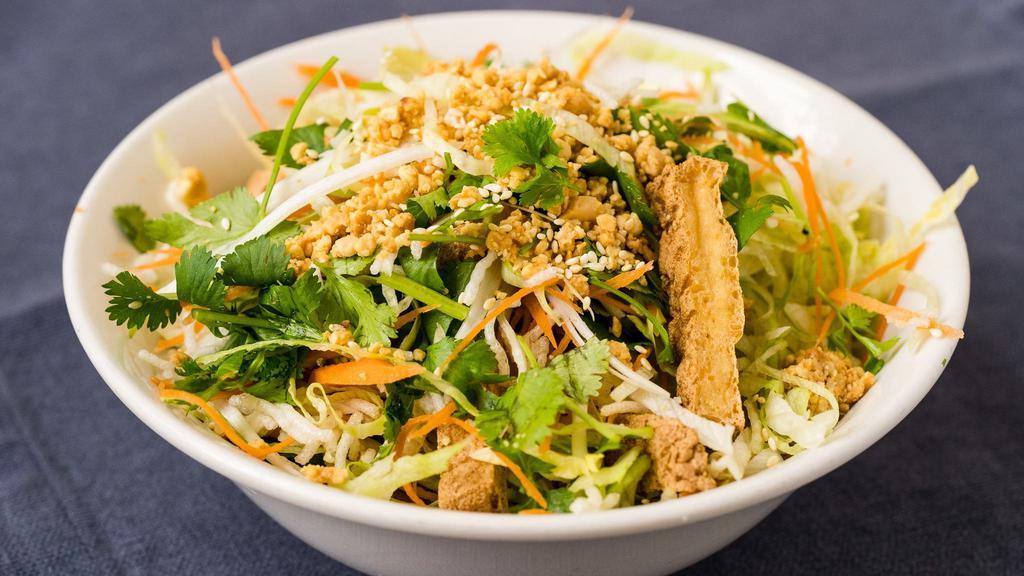 Vegetarian Salad · Vegetarian. Crispy tofu, lettuce, carrots, cilantro, scallions, and rice sticks with peanuts and sesame seeds. Served with a side of lemon-soy vinaigrette.