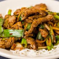 Mongolian Beef · Gluten-free. Spicy and stir-fried with onions and scallions, served on a bed of rice sticks.