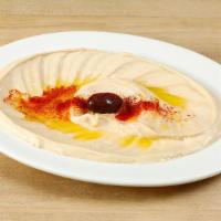 Hummus · Vegetarian. A delightful dip of garbanzo beans with garlic, lemon juice, tahini & olive oil.