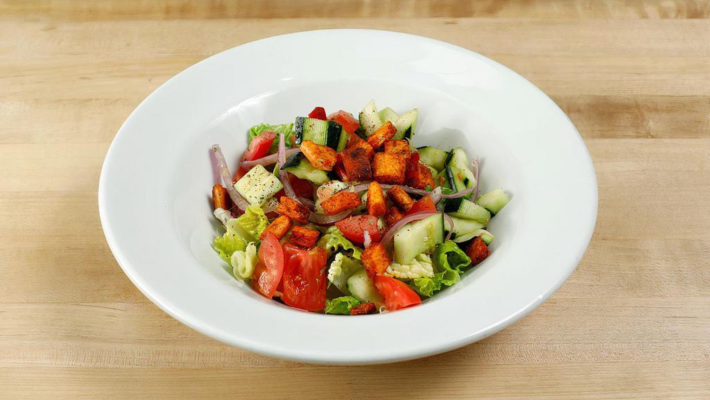 Fattoush Salad · Vegetarian. Romaine hearts, tomatoes, cucumbers, bell peppers, sumac, dry mint, pitta chips, olive oil & lemon dressing.