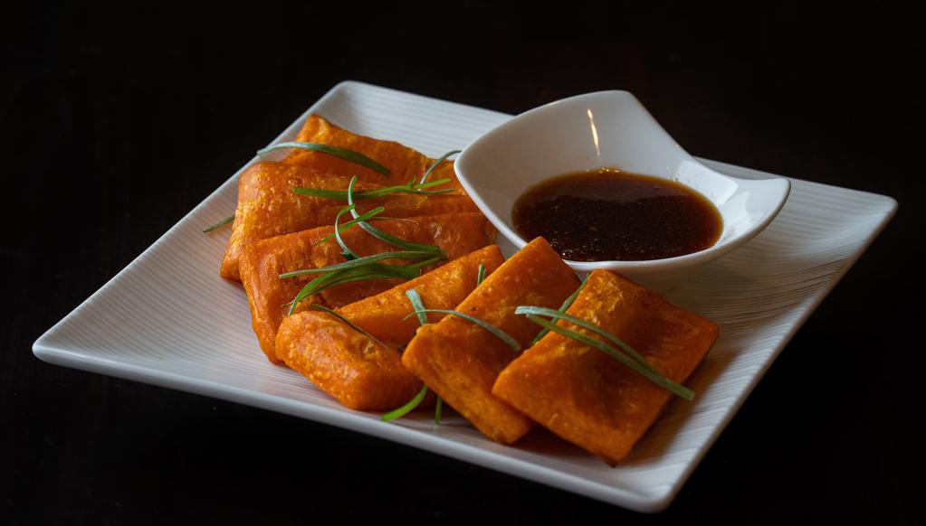 Yellow Tofu · House-made yellow bean tofu is a unique Burmese treat. Silky soft center with a slightly crispy crust. Served with a sweet and tangy dipping sauce.