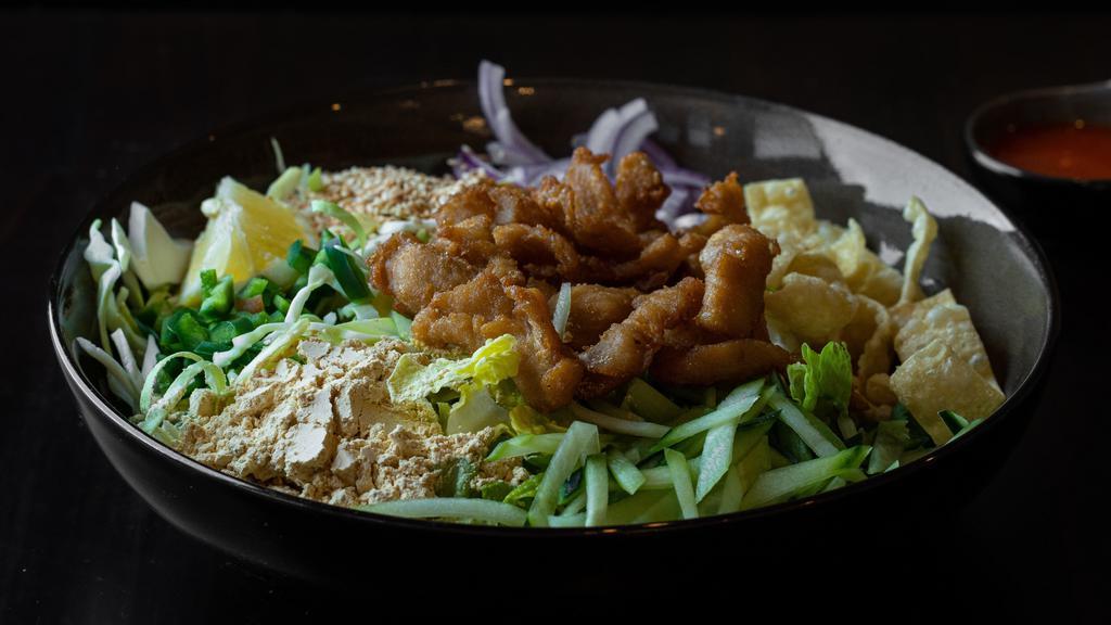  Burmese Chicken Salad · Bite-sized fried chicken with red onions, yellow bean powder, cabbage, cilantro, fried wontons, fried onions, sesame seeds, onion oil and sauce on a bed of romaine lettuce. Gluten-free option available.