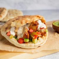 Pita Chicken · Grilled chicken, hummus, cucumber, tomato, pickles, and tahini
