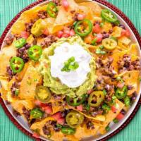Super Nachos · Plate of fried tortilla chips covered in ground beef or chicken with shredded cheese, beans,...