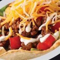 Taco Salad · Fried taco salad shell filled with refried beans, seasoned ground beef or chicken, lettuce, ...