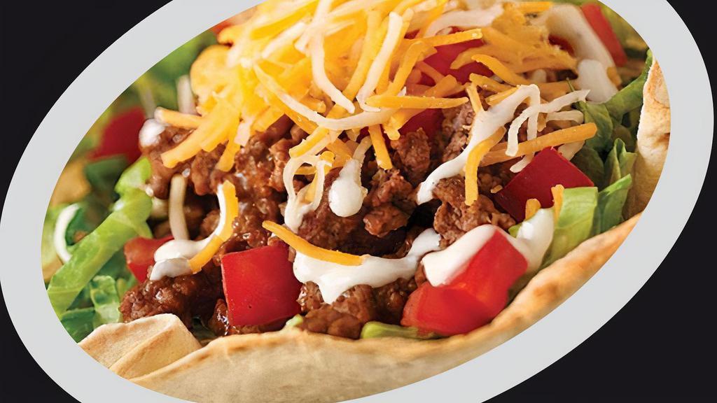 Taco Salad · Fried taco salad shell filled with refried beans, seasoned ground beef or chicken, lettuce, tomatoes, sour cream and salsa.