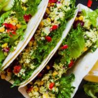 Vegetarian Taco · A taco filled with house rice, beans, lettuce, tomatoes, cheese and sauce