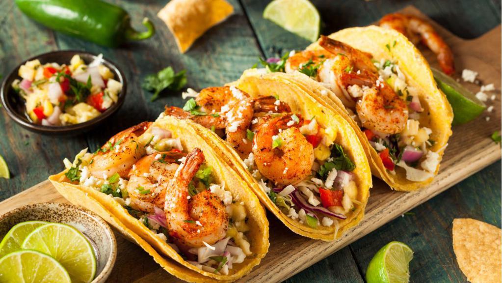 Shrimp Taco · A taco filled with grilled shrimp, lettuce, tomatoes, cheese and sauce