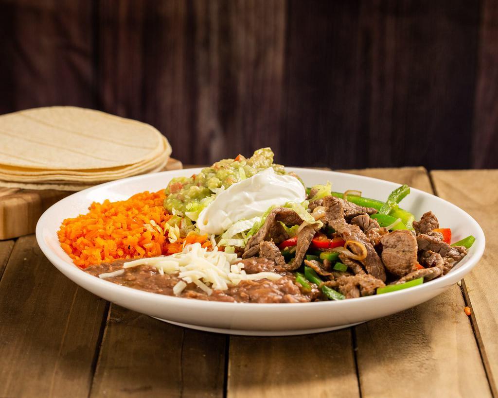 Beef Fajita Plate · Beef steak mixed with bell pepper and onion, rice, beans, cheese, lettuce, tomato and 5 corn tortillas.