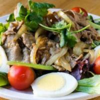 Warm Beef Salad · Sauteed beef, mixed baby greens, boiled egg, and soy vinaigrette.