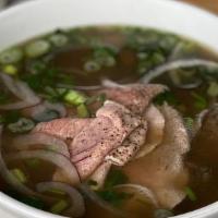 Pho Bo · Rare beef and brisket with rice noodles in beef broth. Finished with Chinese celery, cilantr...