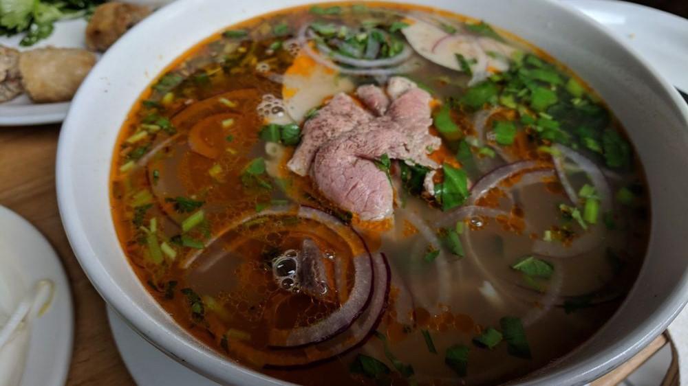 Vegetarian Bun Bo Hue · Mushrooms, pineapple, tofu, spicy vegetable broth, thick vermicelli noodle. Garnishes of cabbage, bean sprouts, jalapeños, and lime upon request.
