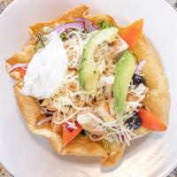 Taco Salad · Crispy taco shell filled with green salad, rice, beans, cheese, sour cream, & your choice of...